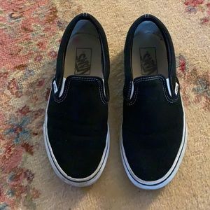 Black slip on vans, somewhat worn